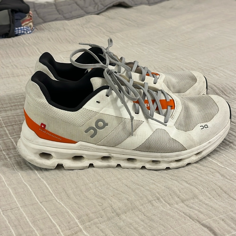 On Running White and Orange Athletic Shoes